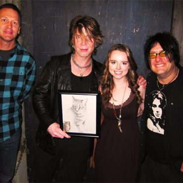 The Goo Goo Dolls with Artist Chelsea Smith. John Rzeznik, the singer of The Goo Goo Dolls is holding a pet portrait of his cat that Chelsea had created for him for his birthday.