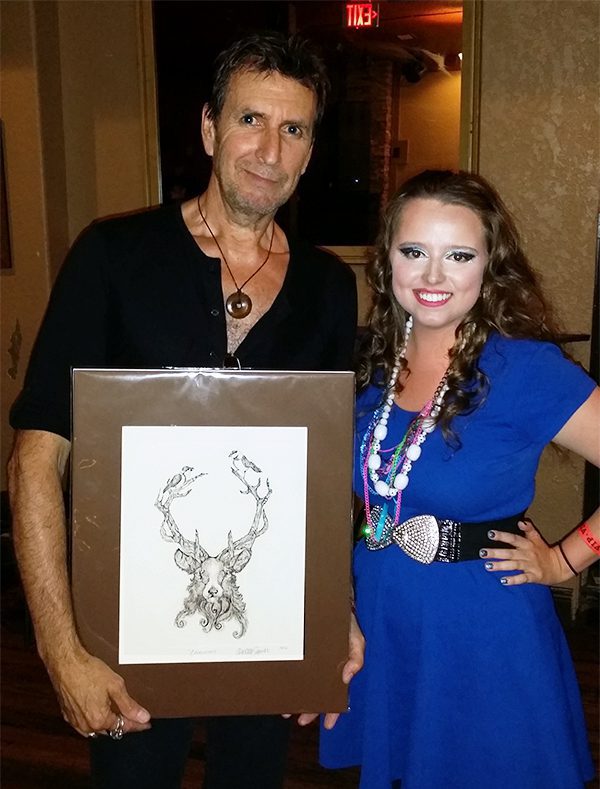 Cy Curnin, Singer of the band The Fixx with Artist Chelsea Smith holding up an original etching print of "Cernunnos" Stag she created for him.